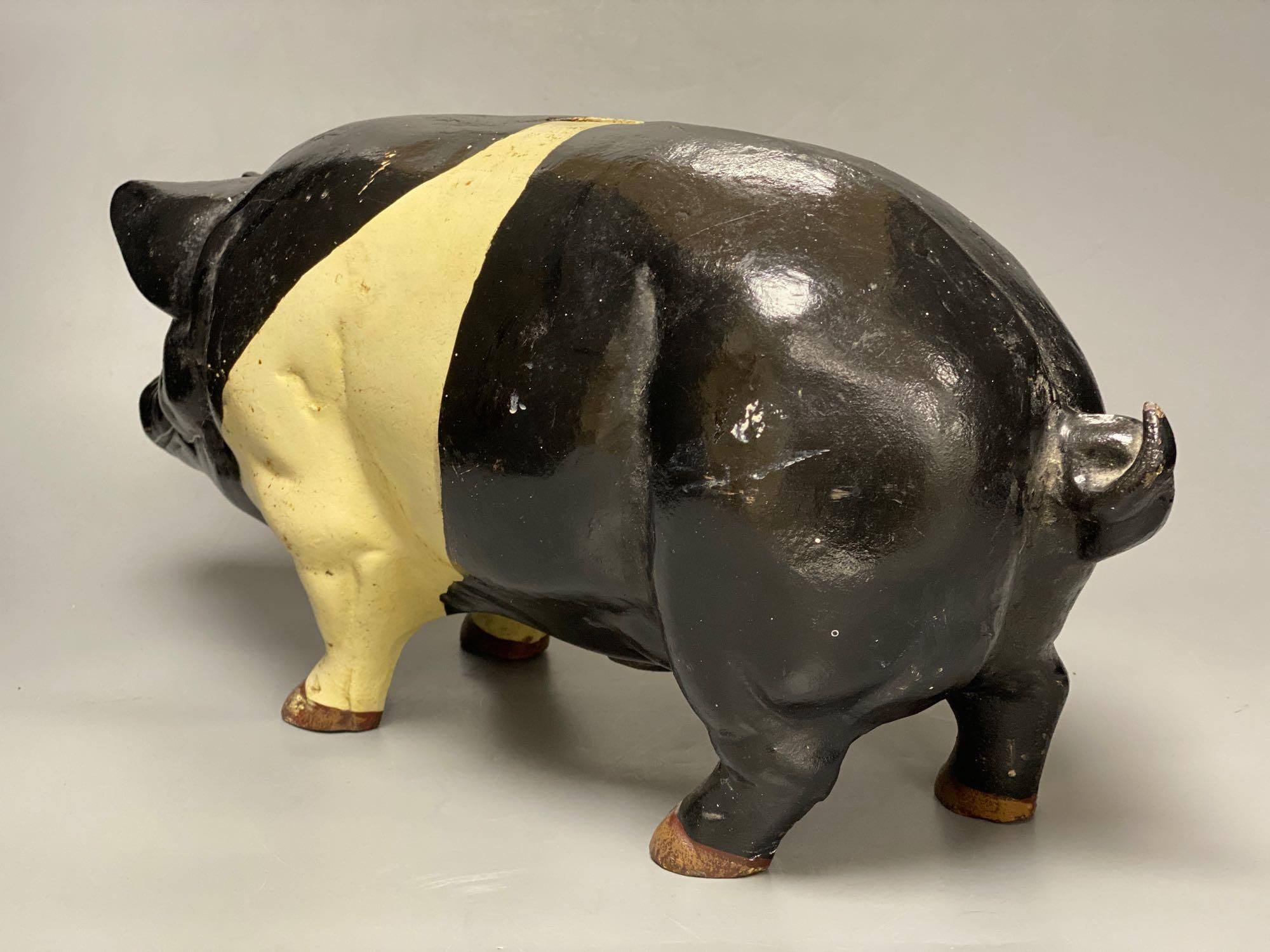 A large heavy cast iron saddle back pig money bank, circa 1950s, length 46cm